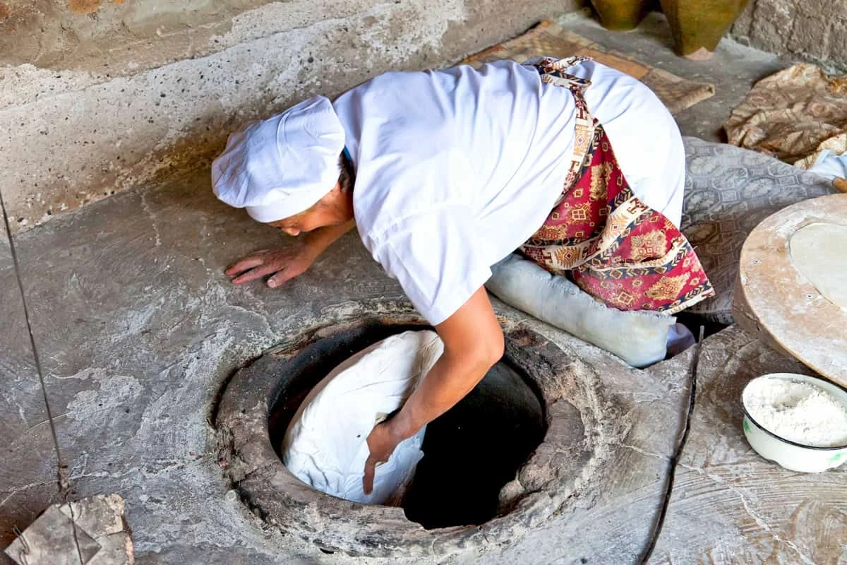 Baking lavash in a traditional Armenian tonir Armenian culture – unique traditions of the Armenian people: Baking lavash in a traditional Armenian tonir